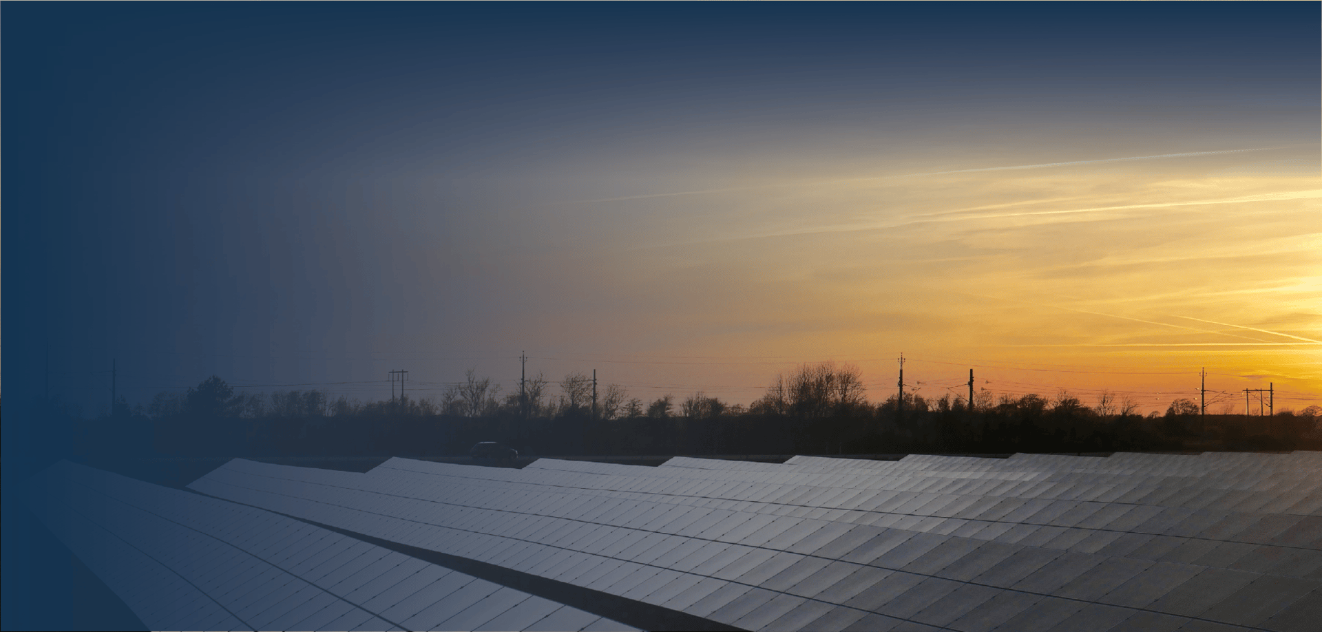 Solar panels covered with reflective surfaces are lined up in the foreground, while a vibrant sunset with soft clouds blankets the horizon. The scene is framed by a gradient blue tone fading into the bottom.