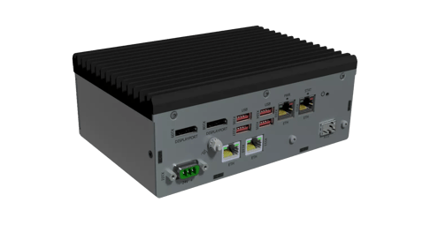 A compact industrial computer with a ribbed metallic casing, featuring various ports including USB, Ethernet, and HDMI, along with a power input and terminal block.