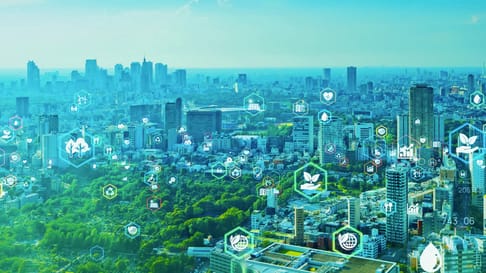 A panoramic view of a city skyline with various eco-friendly and tech-themed icons overlaying the scene, symbolizing sustainability and innovation in urban environments.
