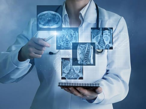 A healthcare professional in a white coat holds a tablet while interacting with floating images of medical scans, including brain and organ visuals. The background features a digital, futuristic design.