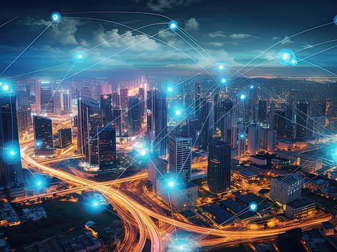 Aerial view of a vibrant city skyline at night, illuminated buildings, and dynamic light trails from vehicles. Digital network connections represented by glowing dots and lines overlay the scene, symbolizing connectivity and technology.