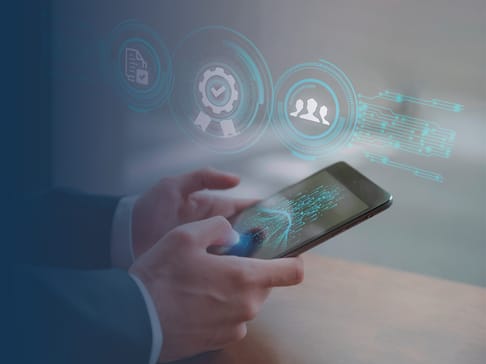 A person in a suit holds a smartphone, with digital icons of security, quality, and user profiles floating above the device, suggesting themes of technology and communication.
