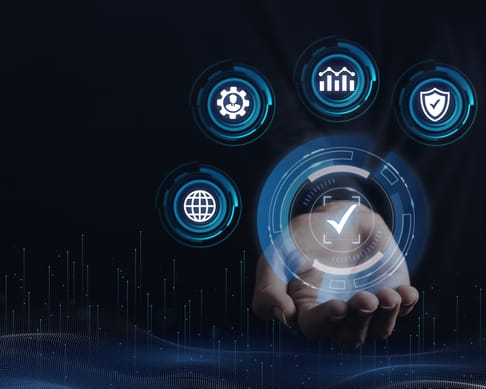 A hand is holding a holographic interface featuring icons that represent technology concepts like data analysis, security, and global connectivity against a dark background.