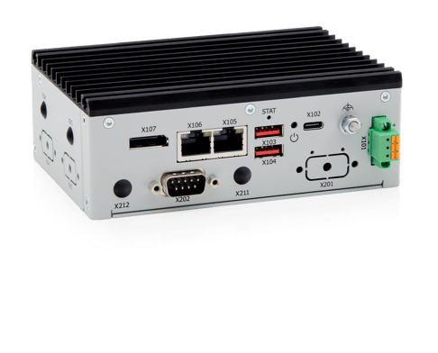 A compact gray industrial device with various ports and connectors on one side, including Ethernet, USB, and serial ports. The device has a ribbed top and is designed for mounting or integration in technical systems.